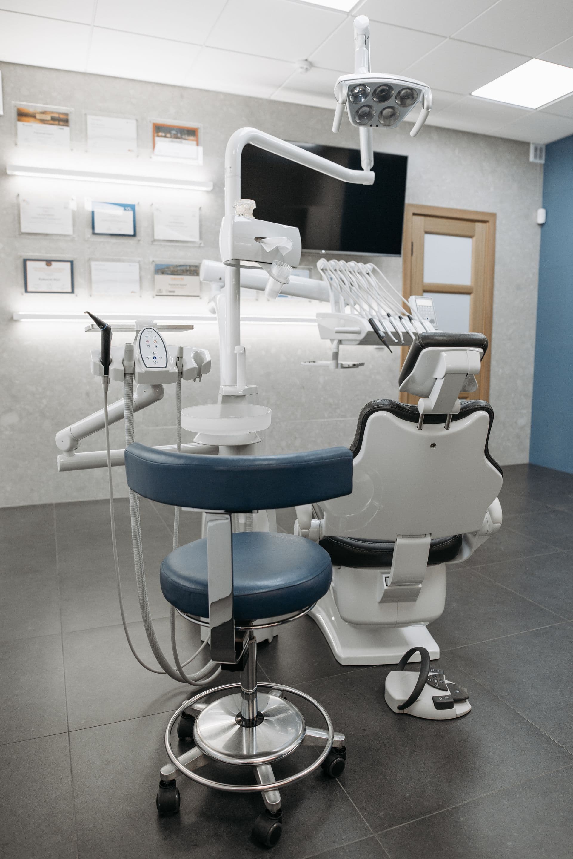 Modern dental treatment room with a computer beside the chair